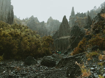 Panoramic view of trees and mountains against sky