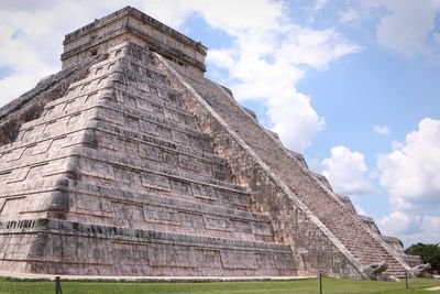 Low angle view of temple against cloudy sky