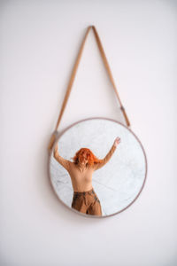 Woman wearing mask against white background