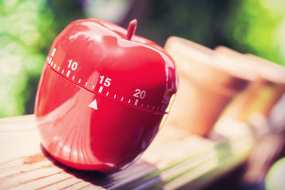 Close-up of red container on wooden table