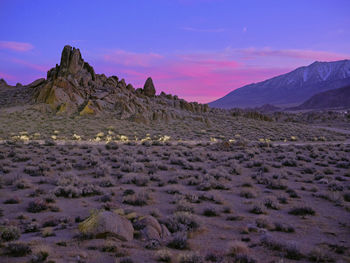 Sunset in the alabama hills, cotton candy clouds, rock formations.