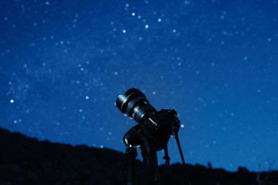 Low angle view of man standing against sky