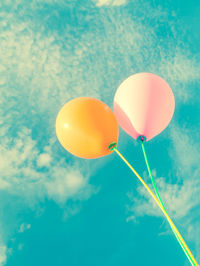 Low angle view of balloons against blue sky