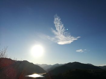 Scenic view of mountains against blue sky