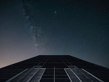 Low angle view of modern building against sky at night