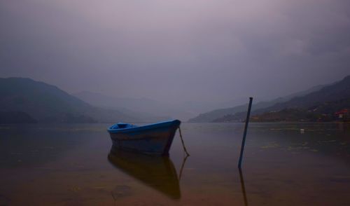 Boat on lake against sky