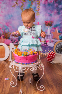 Close-up of baby girl eating birthday cake