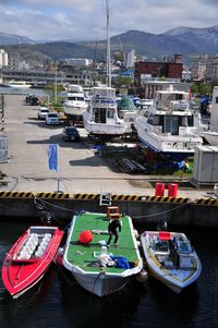 Boats in river with city in background