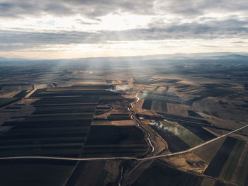 Aerial view of landscape against cloudy sky