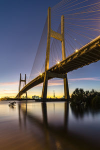 Low angle view of suspension bridge against sky