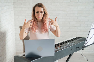 Portrait of young woman playing piano