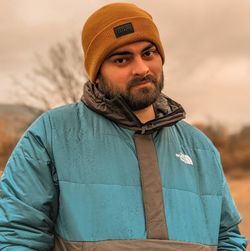 Portrait of man wearing hat standing outdoors