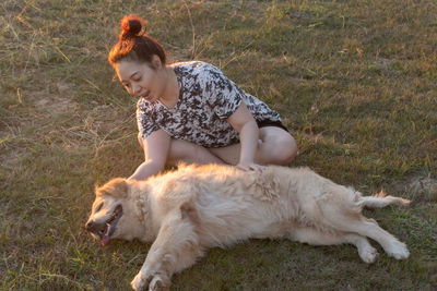 Full length of man with dog on field