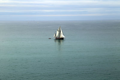 Sailboat in sea against sky