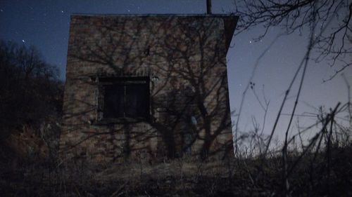 Abandoned building against sky at dusk