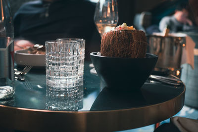 Close-up of food and glasses on table.