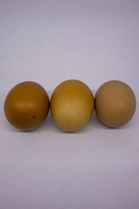 Close-up of eggs against white background