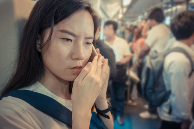 Woman talking on phone in train