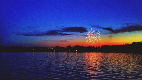 Reflection of clouds in sea at dusk