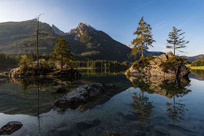 Scenic view of lake by mountain against sky