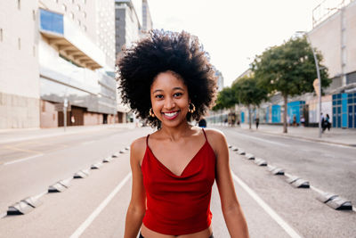 Portrait of young woman standing in city