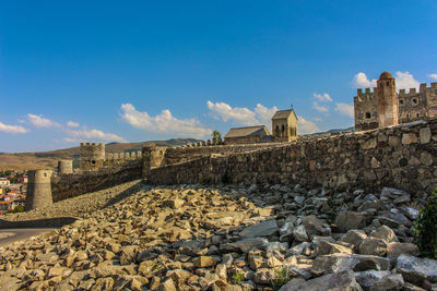 View of abandoned building against blue sky