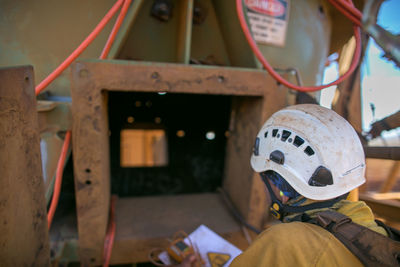 Rear view of construction worker using machinery