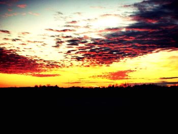 Scenic view of silhouette landscape against orange sky