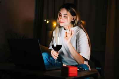 Mid adult woman using mobile phone at home