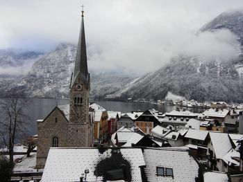 Buildings in city against sky during winter