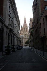 Street amidst buildings against sky in city