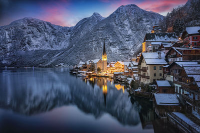 Panoramic view of buildings and mountains against sky during winter