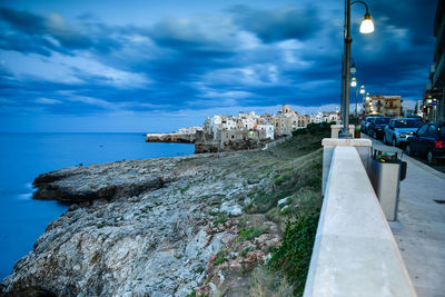 Panoramic view of sea and buildings against sky