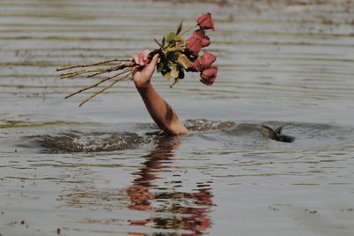 Man holding ice cream in water