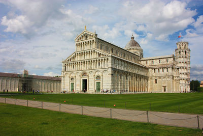 Cathedral of the pisa tower on the grass of piazza dei miracoli in tuscany