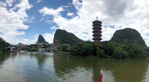 View of temple by building against sky