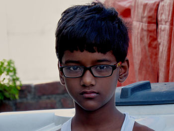 Close-up portrait of boy wearing eyeglasses outdoors