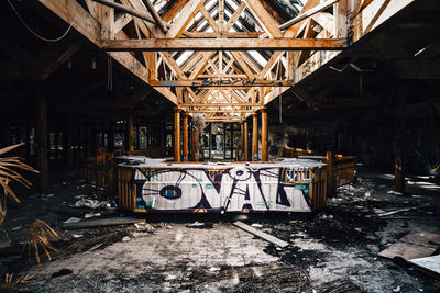 Graffiti on table inside abandoned building