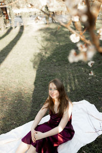 Portrait of young woman sitting on road