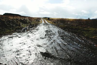 Scenic view of land road against sky