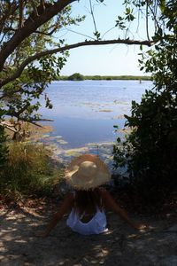 Rear view of woman looking a lagoon mangrove 