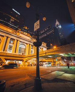 Illuminated city street at night