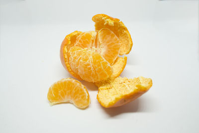 Close-up of orange slice against white background