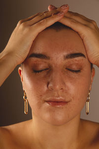 A swarthy girl with short hair and freckles with closed eyes. authentic close-up portrait