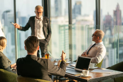 Group of people looking at camera on table