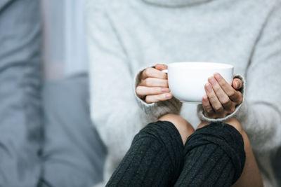 Midsection of woman using mobile phone