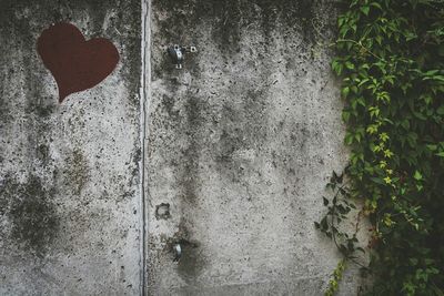 Close-up of heart shape on brick wall