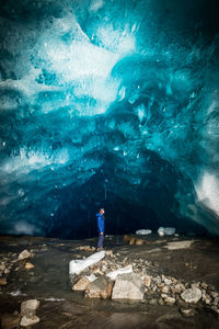 Full length of man standing on rock in sea