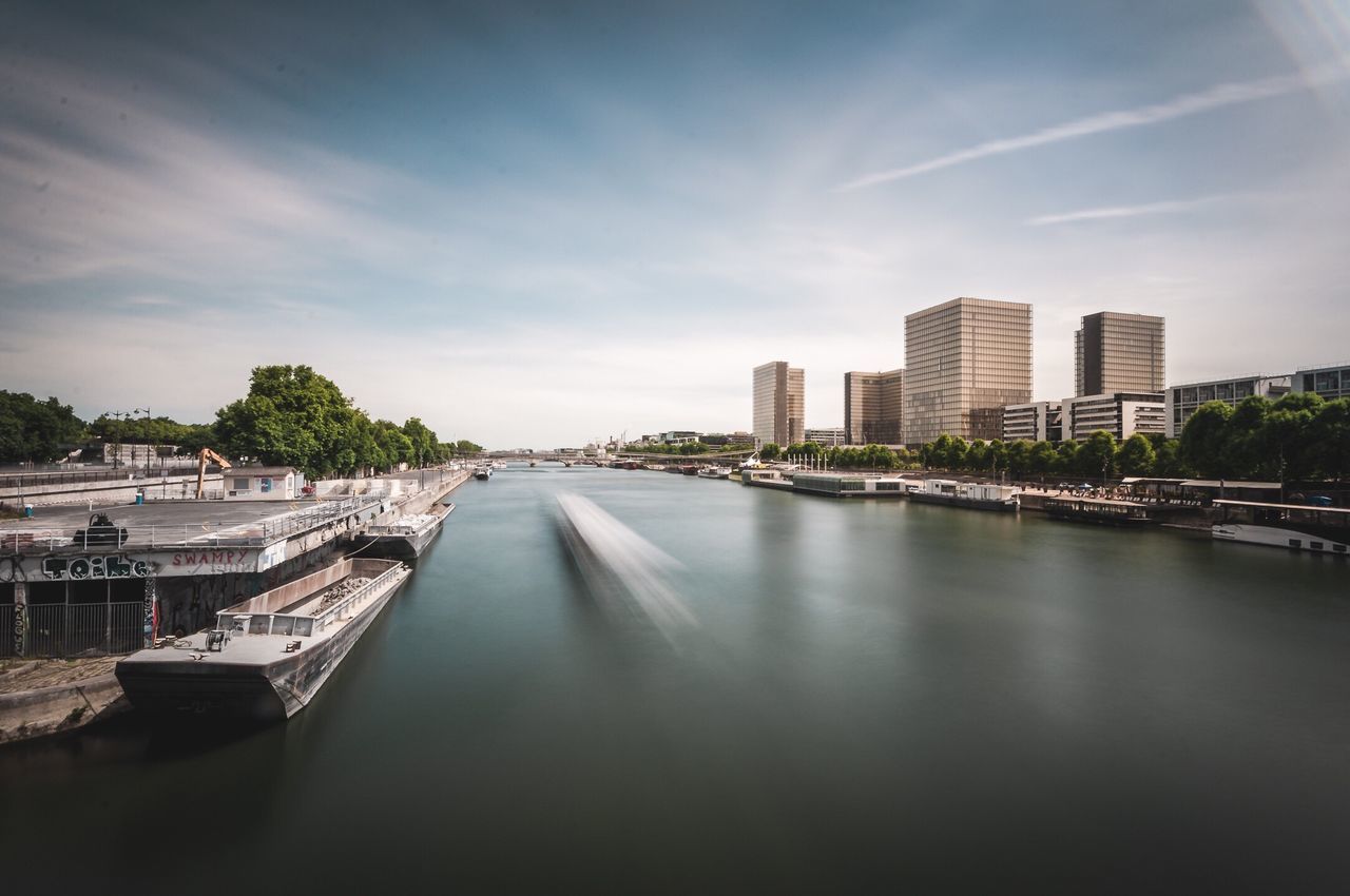 architecture, city, built structure, skyscraper, cityscape, building exterior, sky, water, river, downtown district, travel destinations, modern, no people, urban skyline, outdoors, day, tree, nature