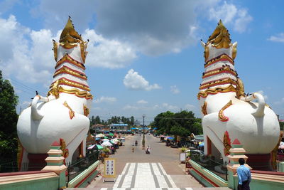 Statue against temple building against sky